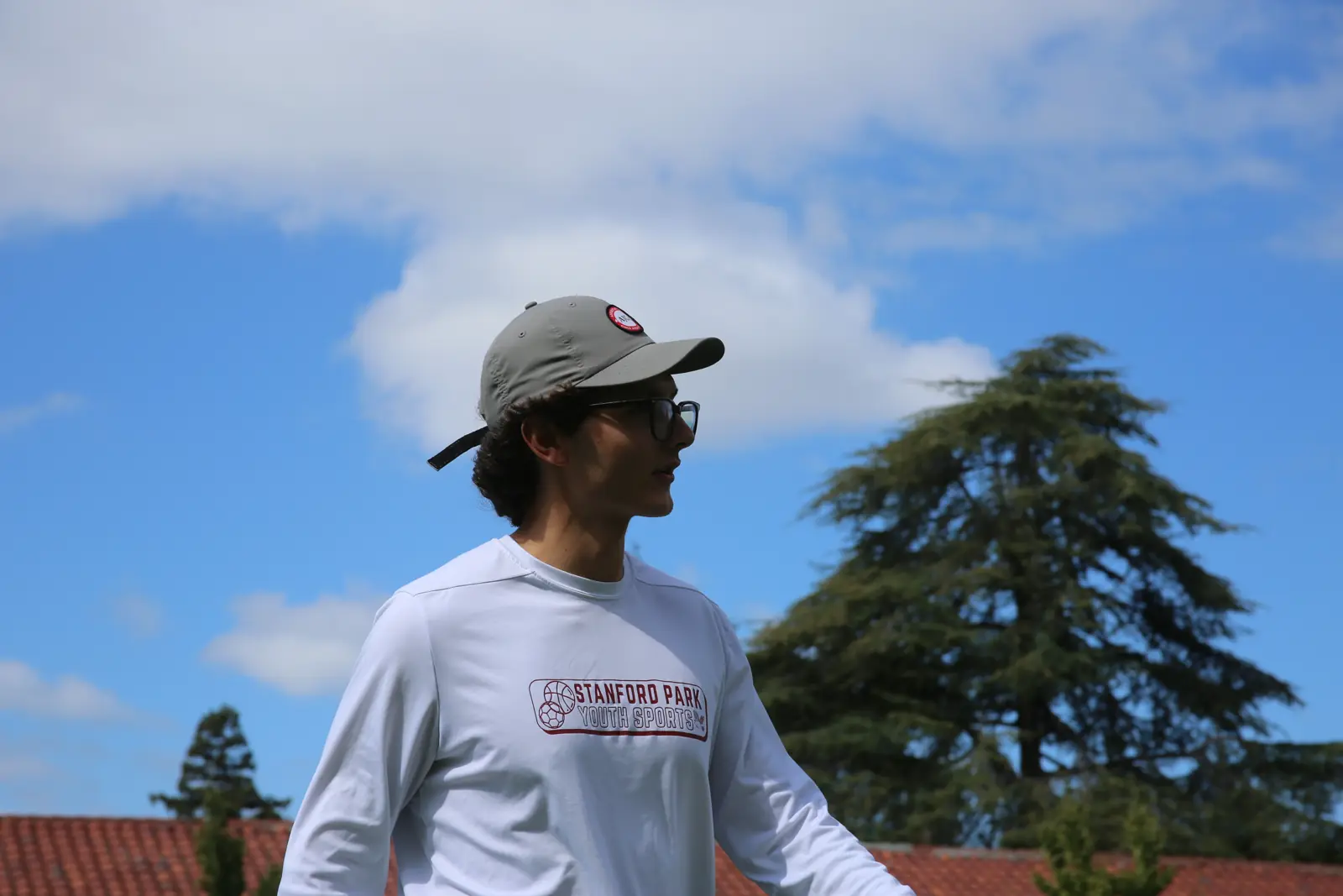 Smiling Stanford Park Sports coach on the school field